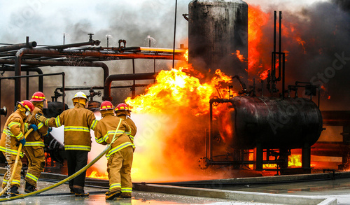Firefighters practice in a refinery