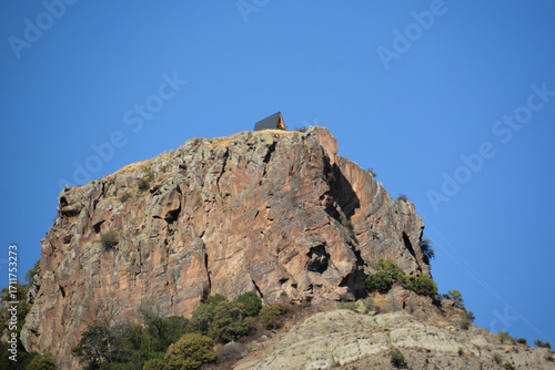 Wooden cottage on the mountain. House on the top of a cliff. Rocky Mountains and house. Mountain holidays