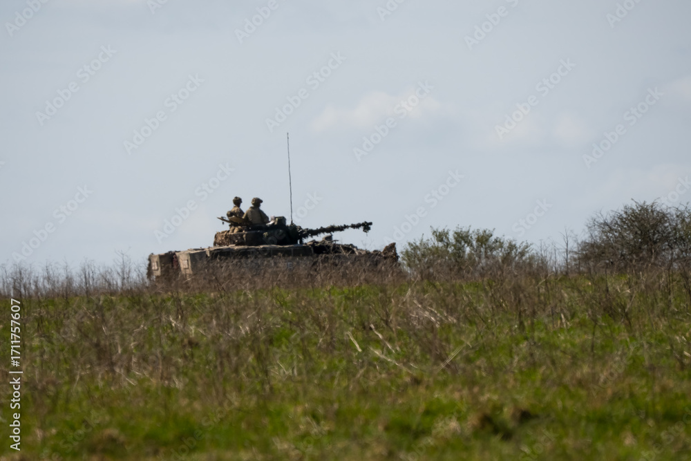 Naklejka premium British army Warrior FV510 IFV tank in action on a battle exercise