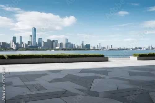 Modern city skyline with clear blue sky and open plaza