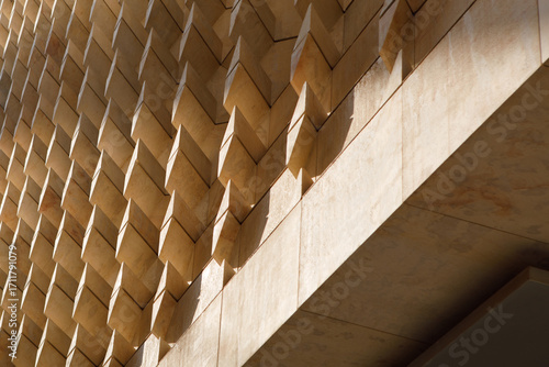Modern Parliament Building Facade with Geometric Stone Panels and Shadows