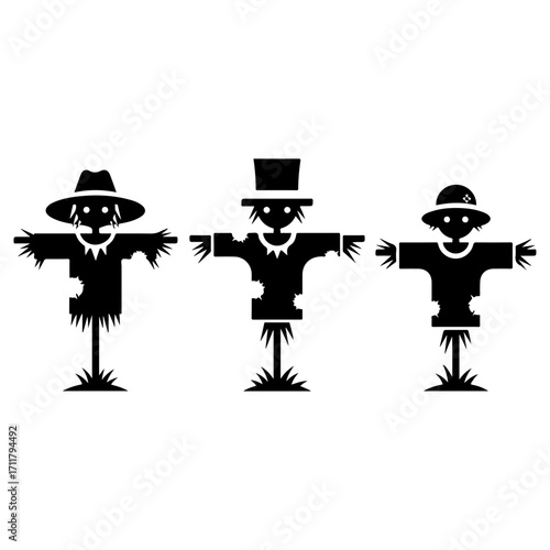 Three scarecrows in silhouette standing in a row.