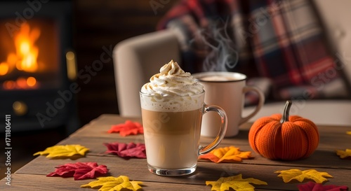 Fototapeta Naklejka Na Ścianę i Meble -  A cozy autumn scene with a pumpkin spice latte, a warm fireplace, and colorful fall leaves on a wooden table.