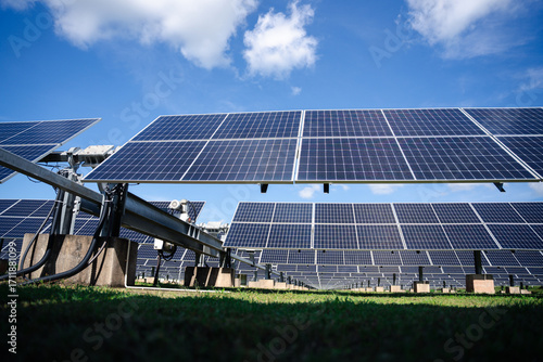 Ground-mounted solar panels with sturdy metal framing and wiring system, engineered for efficient large-scale outdoor renewable power generation in farms and industrial fields