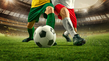 Soccer players uniforms competing for control of soccer ball on lush grass in stadium, spikes dig into turf as intensity increases. Concept of sport championship, match, tournament. Ad