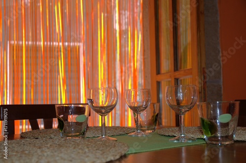 Six glasses on a table. Interior of a traditional restaurant in a small town in Tuscany