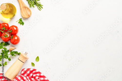 Fototapeta Naklejka Na Ścianę i Meble -  Spices, herbs and vegetables with olive oil on white kitchen table.