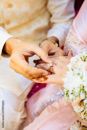 Wedding Ring Ceremony: A Close-Up of Hands and a Diamond Ring
