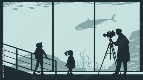 Silhouette of children watching an aquarium with a cameraman filming the scene.