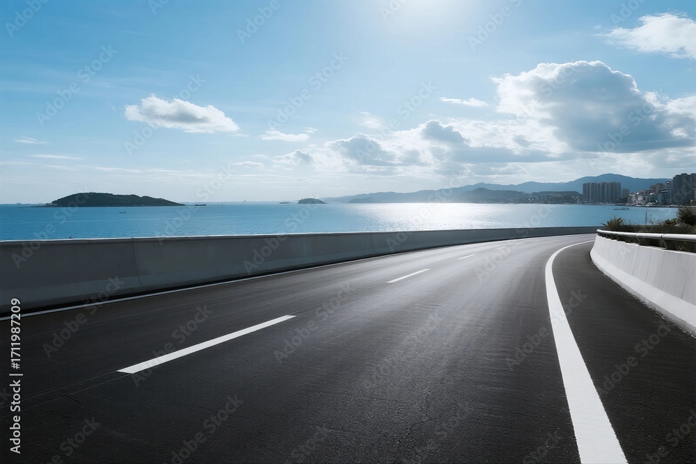 Fototapeta premium Smooth asphalt road extending towards the scenic sea and sky