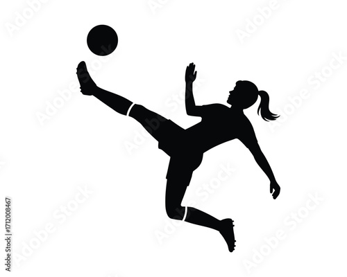 Silhouette of a female soccer player kicking a ball