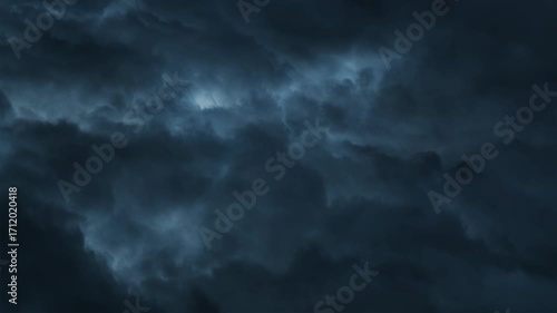 Top-down view of clouds with white and blue-white lightning flashing below in endless loop. Symbolizes catastrophe, horror and despair.