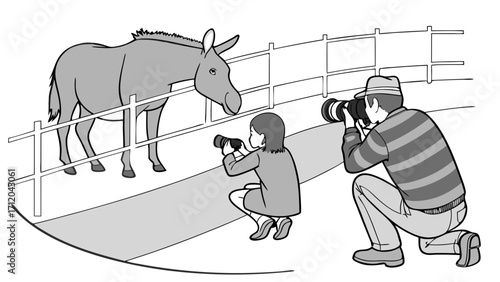 Two photographers taking pictures of a donkey behind a fence.