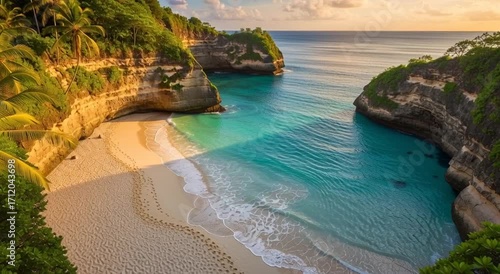 Aerial view of diamond beach with turquoise water, palm trees, and rocky cliffs in nusa penida, bali