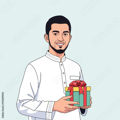 Smiling young Muslim man in traditional white clothing holding a gift.