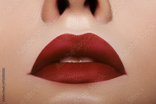 Beautiful Woman Lips with Fashion Bloody Red Lipstick Makeup. Beauty Surgery with fillers or Fashion Make-Up Concept. Passionate kiss on Valentines Day or bloody on Halloween. Female Sexy Open Mouth