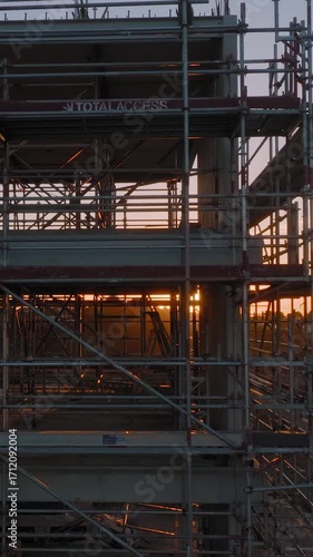 Wallpaper Mural Golden hour light shines through scaffolding on a construction site. The metal framework creates interesting shadows as a building is erected. Torontodigital.ca