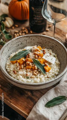 Winter squash risotto with toasted pine nuts, Brie cheese. Rustic cottagecore autumn table serving.