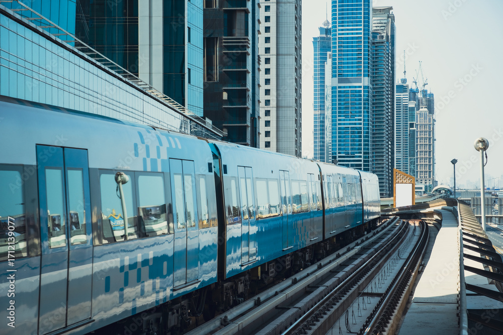 Fototapeta premium City skyline with metro train running along elevated railway tracks, surrounded by glass towers and modern office skyscrapers, downtown urban business district, 4k stock image