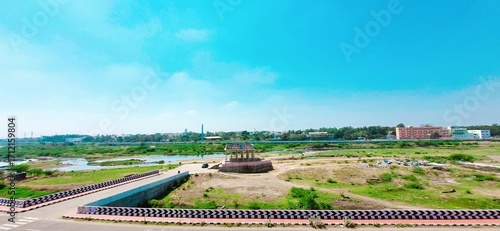 Thenoor Mandabam standing prominently on the banks of the Vaigai River in Madurai, Tamil Nadu, India, with clear skies and urban surroundings in the backdrop