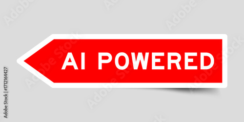 Red color arrow shape sticker label with word AI powered on gray background