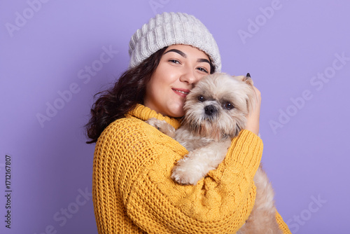 A cute young woman holding her adorable white pet shih tzu