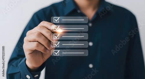 A person in a blue shirt is marking off items on a digital checklist with a pen in a bright environment