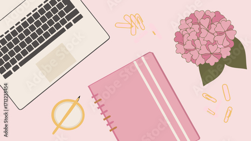 Flat lay of laptop notebook flowers and stationery on pink background.