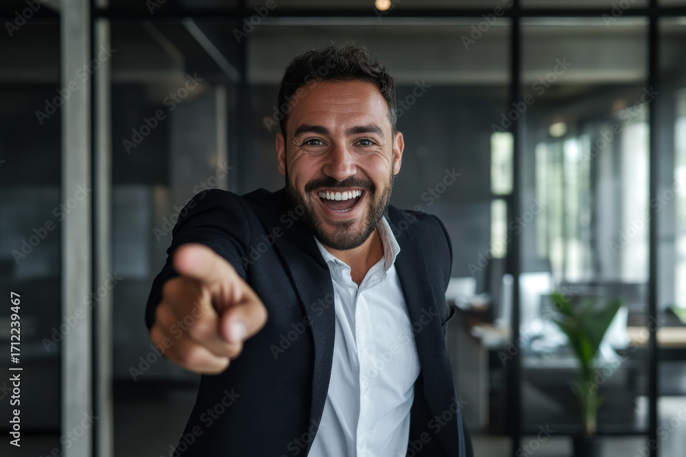 Fototapeta premium happy surprised businessman pointing at you in modern office background
