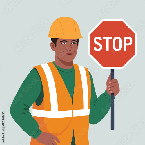 Construction worker holding a stop sign with a neutral background behind him