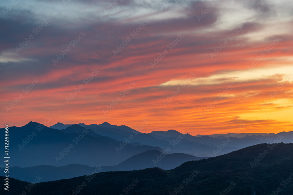 Fototapeta premium Overlooking magnificent sunset glow over mountains