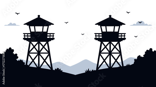 Silhouette of two observation towers in mountainous landscape  