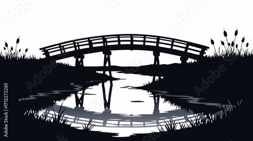 Silhouette of a wooden bridge reflected in calm water at dusk  