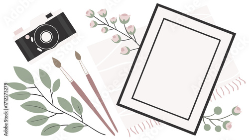 Flat lay photography mockup with camera paintbrushes flowers and blank frame for design and art projects.