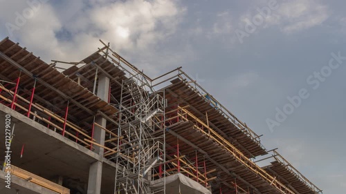 Construction Site with Scaffolding and Building Framework under Cloudy Sky Timelapse
