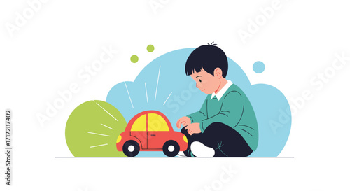 A young boy plays with a red toy car on a white background.