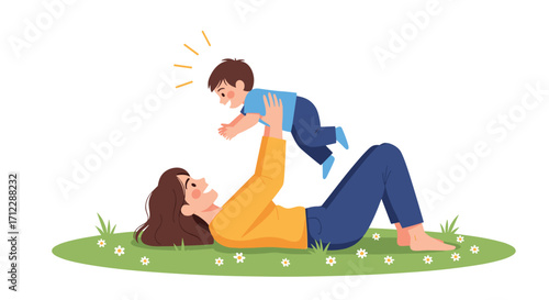 Mother lifting her child up in the air while lying on the grass.