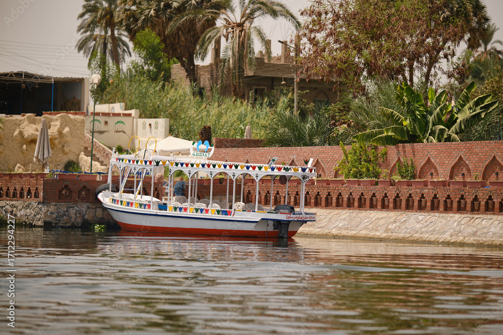 Fototapeta premium Luxor, Egypt- August 13, 2025: Colorful tourist boats on the Nile River in Egypt.