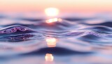 Tranquil ocean waves rippling at sunset with sun reflection creating purple and orange hues on water surface, macro photography showing detailed water movement.