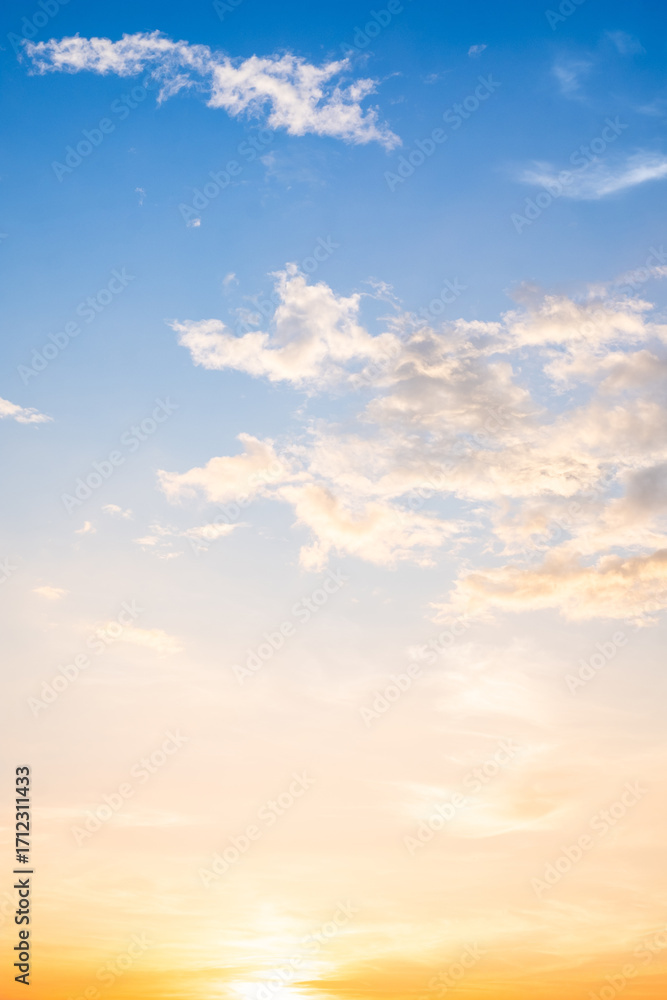 Fototapeta premium Beautiful , luxury soft gradient orange gold clouds and sunlight on the blue sky perfect for the background, take in evening,Twilight, Large size, high definition landscape photo,Vertical