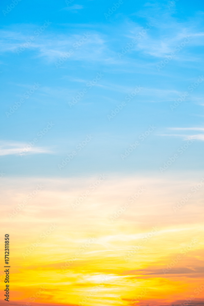 Obraz premium Beautiful , luxury soft gradient orange gold clouds and sunlight on the blue sky perfect for the background, take in evening,Twilight, Large size, high definition landscape photo,Vertical