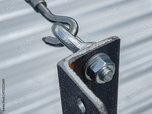 Thread the cable through the bolts on the poles and secure with wire rope clips.