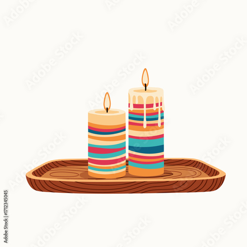 Two colorful striped candles burning on a wooden tray.