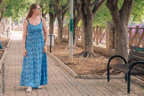Woman sits on the bench in ...