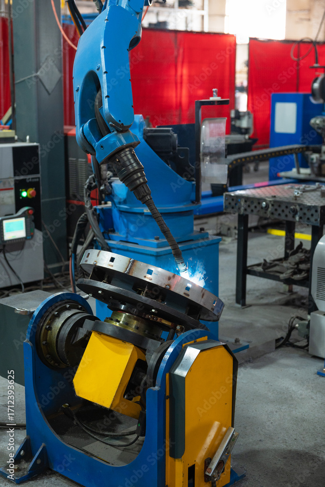 Fototapeta premium Automatic Industrial welding robot in a modern factory in operation.
