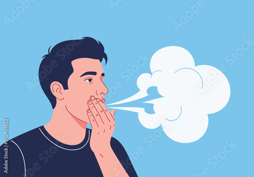 A person exhales a cloud of vapor from their mouth.
