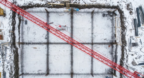 Aerial View of Large Construction Site With Crane and Steel Reinforcement Ready for Concrete Pour in Snowy Conditions