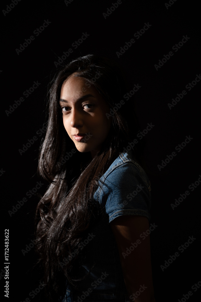 Fototapeta premium Young woman posing in low key lighting portrait
