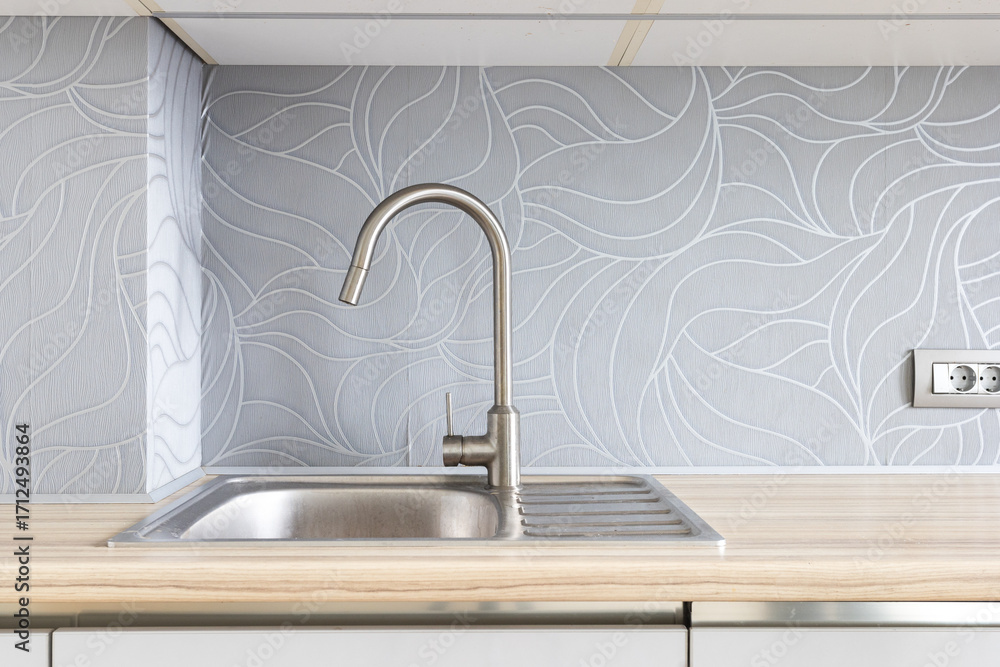 Fototapeta premium kitchen faucet on a stylish metal sink