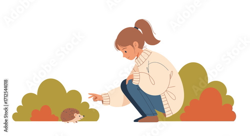 Curious Young Woman Points To A Cute Hedgehog In Autumnal Colored Foliage